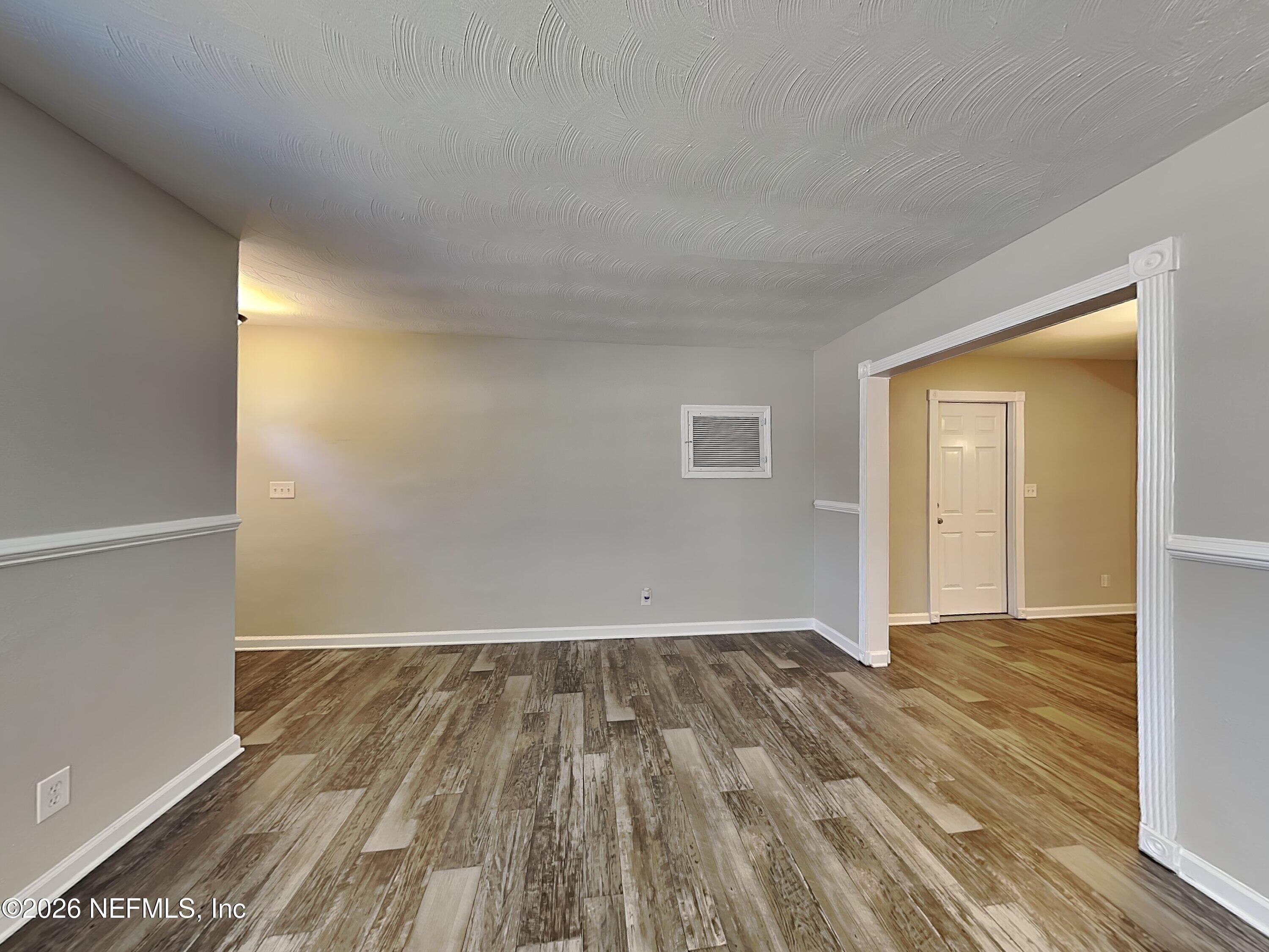 3403 Rogero Road Jacksonville, FL 32277 - Photo 5 of 19 wooden floor in a empty room