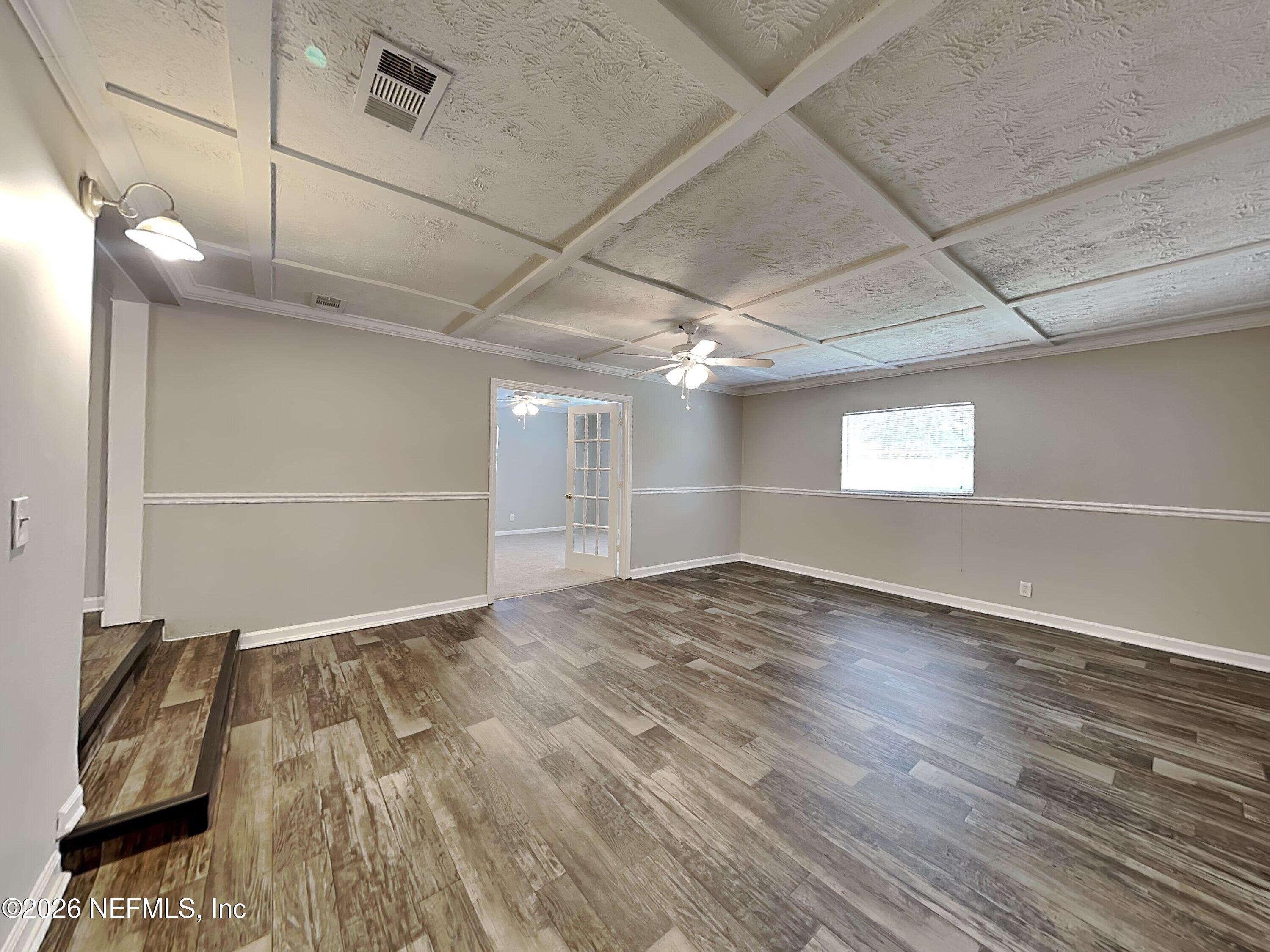3403 Rogero Road Jacksonville, FL 32277 - Photo 7 of 19 a view of empty room with wooden floor