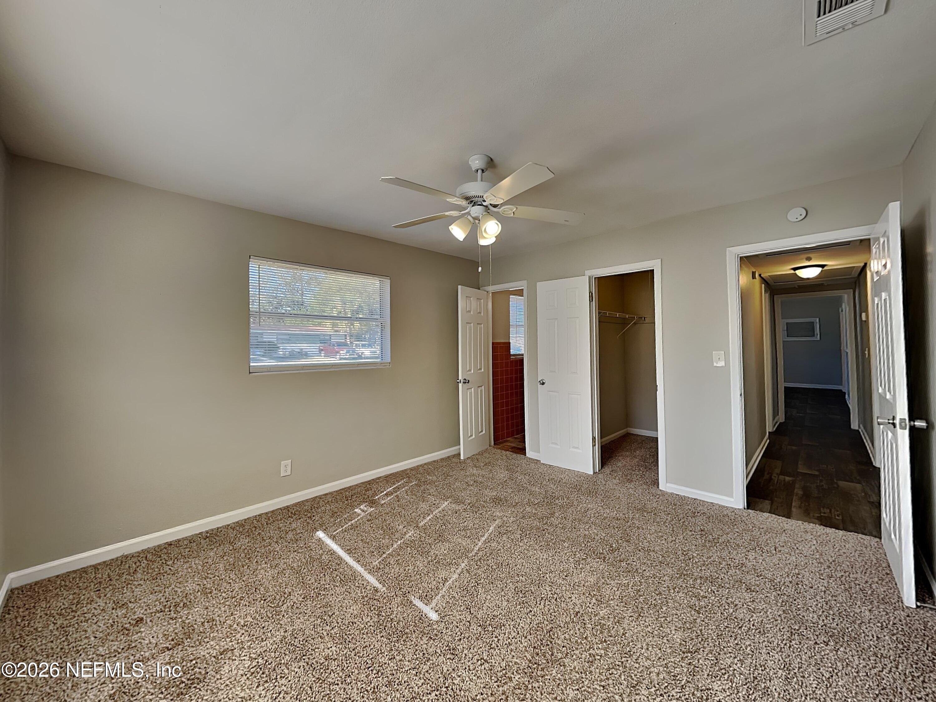 3403 Rogero Road Jacksonville, FL 32277 - Photo 10 of 19 a view of a livingroom with a ceiling fan and window