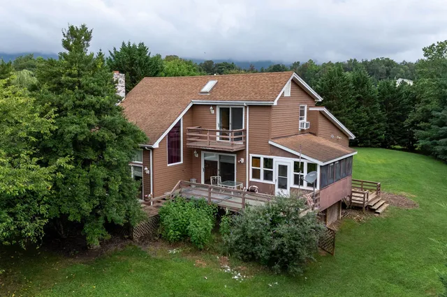 an aerial view of a house with a yard
