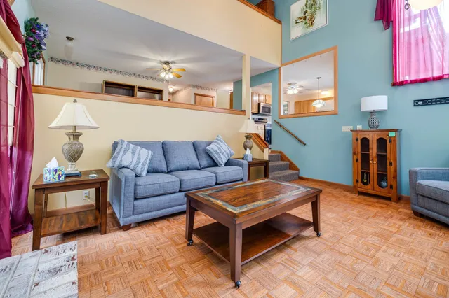 a kitchen with a refrigerator a stove cabinets and a dining table