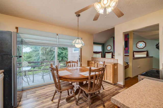 a living room with furniture and a ceiling fan