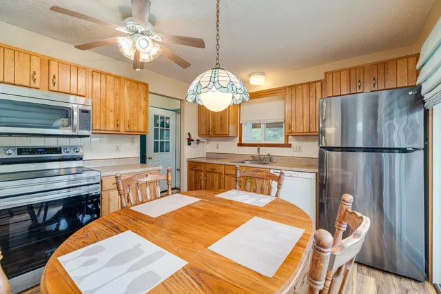 a bathroom with a sink a toilet and shower curtain