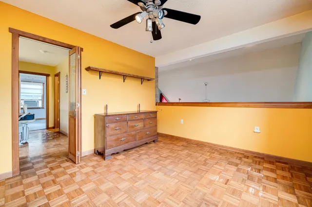 a view of a house with backyard and trees