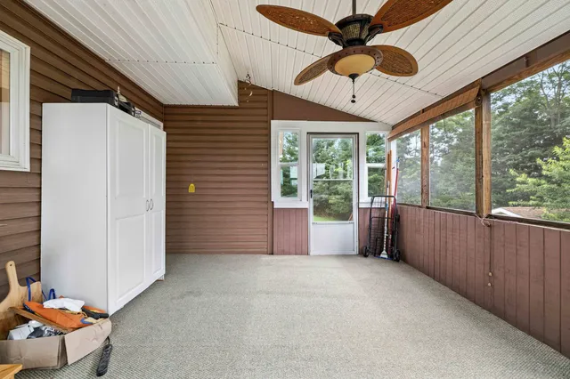 an aerial view of green landscape with trees houses and mountain view