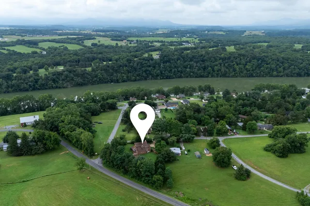 a view of a livingroom with furniture cabinet and a window