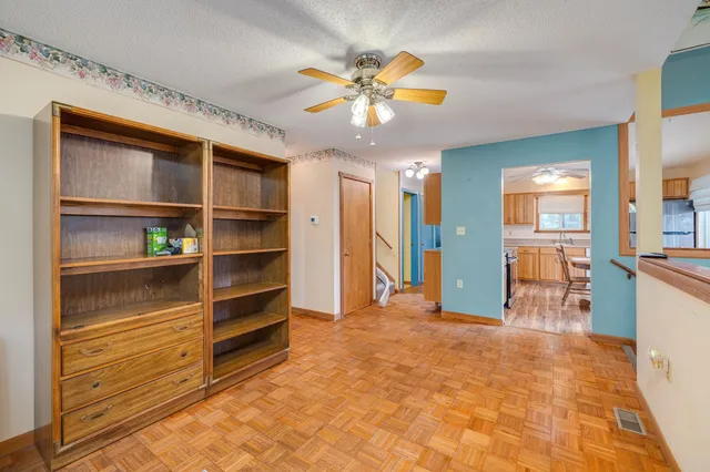 a living room with furniture a table and a bookshelf