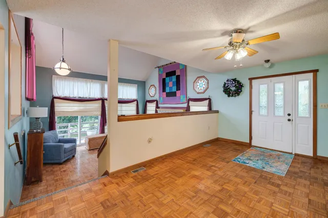 a living room with furniture a rug and a large window