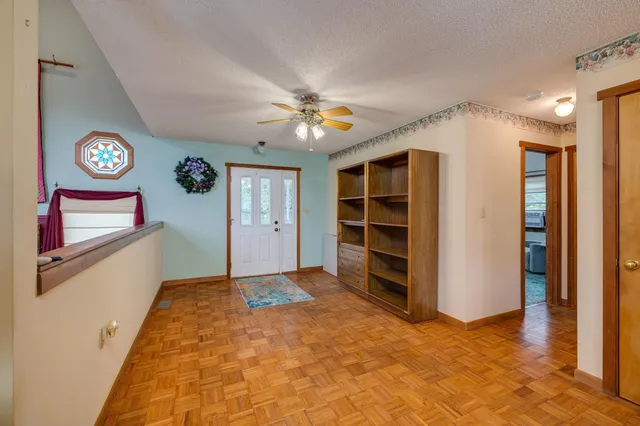 a kitchen with a table chairs stainless steel appliances and cabinets