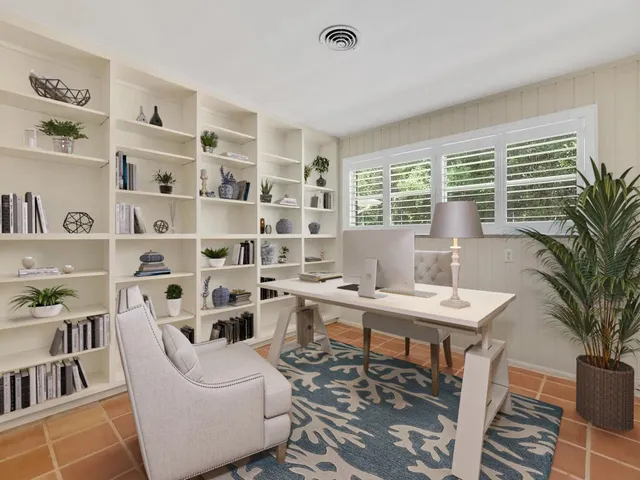 a living room with furniture and a book shelf