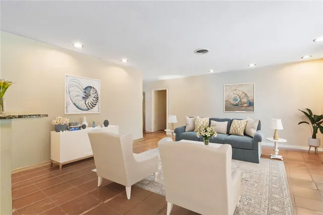 a living room with furniture a clock and a window