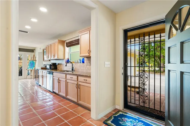 a view of a kitchen with kitchen island granite countertop lots of counter top space and windows