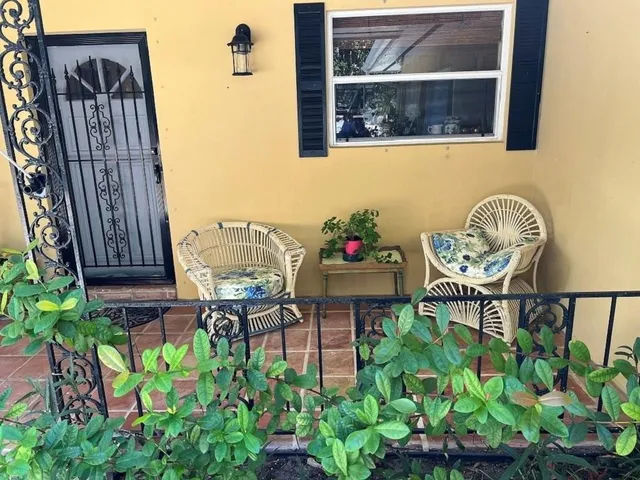 a backyard with table and chairs