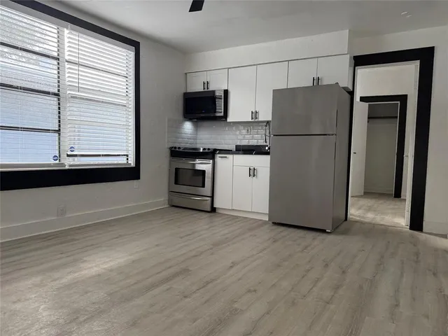 a kitchen with a refrigerator and a stove