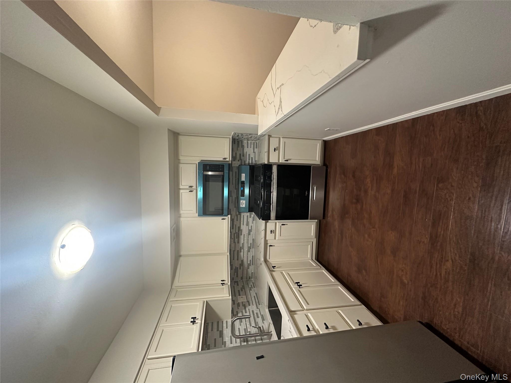 901 Cleveland Street, Unit 1 Brooklyn, NY 11208 - Photo 1 of 1 a kitchen with a stove sink and cabinets