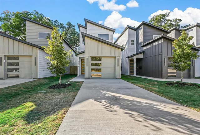 a front view of a house with a yard and a garage