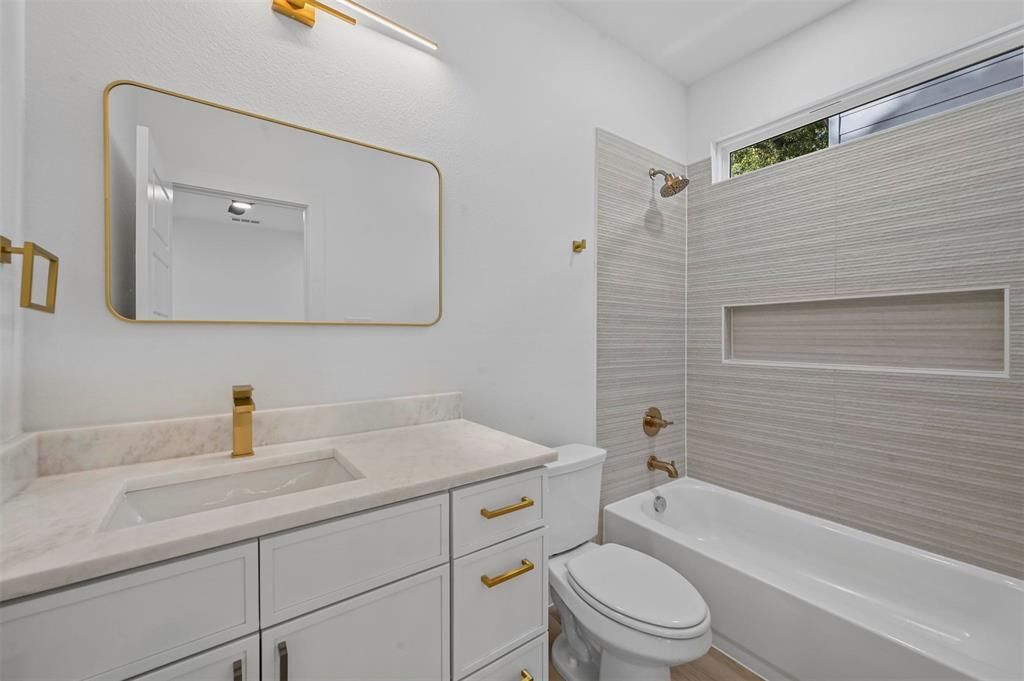 2413 Easley Street Dallas, TX 75215 - Photo 17 of 24 a bathroom with a sink a toilet and shower