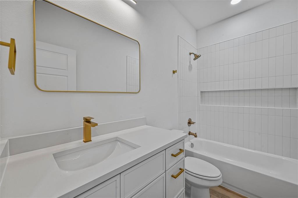 2413 Easley Street Dallas, TX 75215 - Photo 20 of 24 a bathroom with a sink a toilet and shower