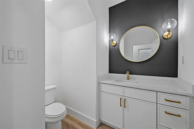 a bathroom with a toilet and a mirror