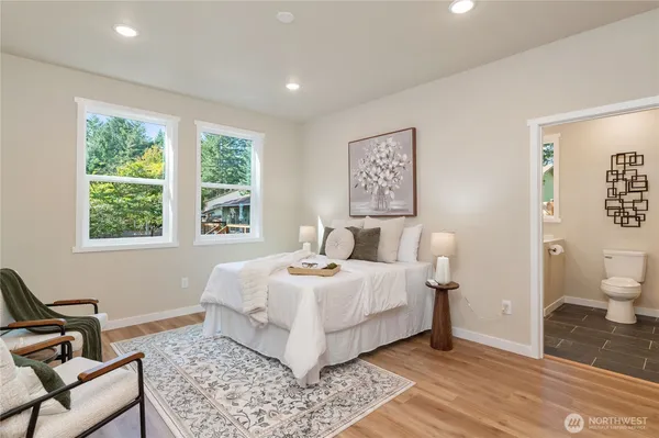 a bedroom with a bed and a chair