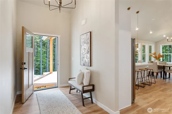 a view of a hallway with furniture and a window