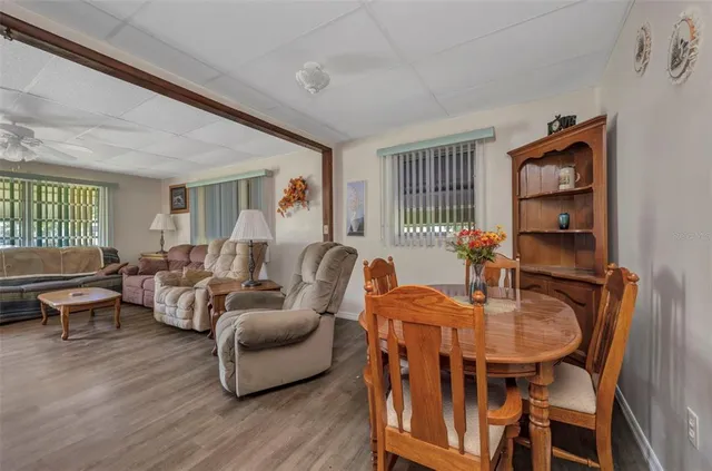 a living room with furniture wooden floor and a window