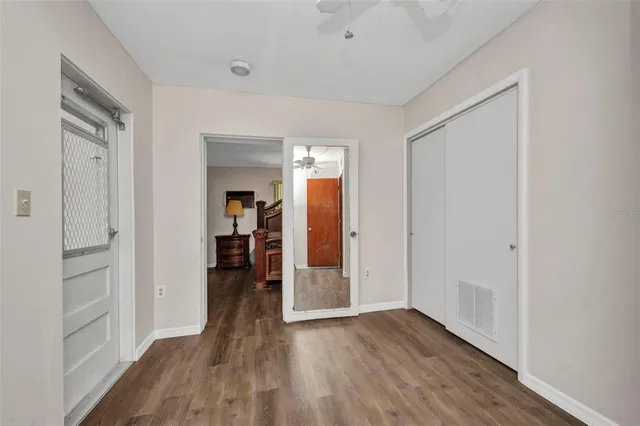 a view of a hallway view with wooden floor and furniture