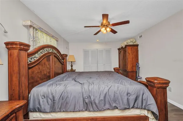 a bedroom with a bed and a mirror