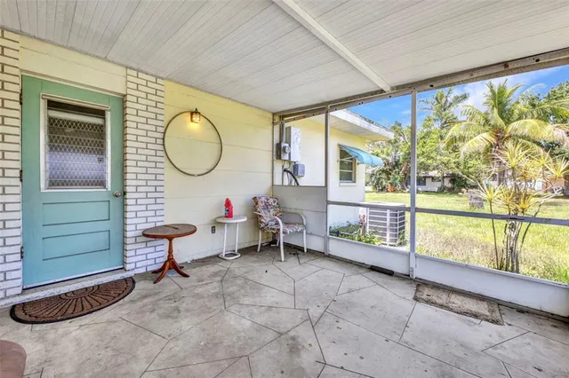 a living room with a large window and furniture