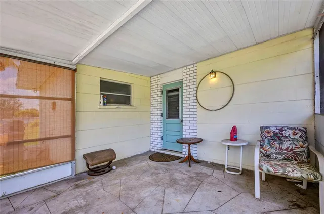 a living room with furniture a mirror and a flat screen tv