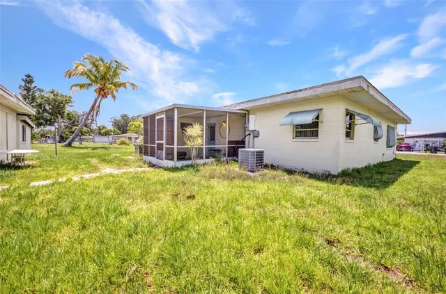 a view of a house with a backyard