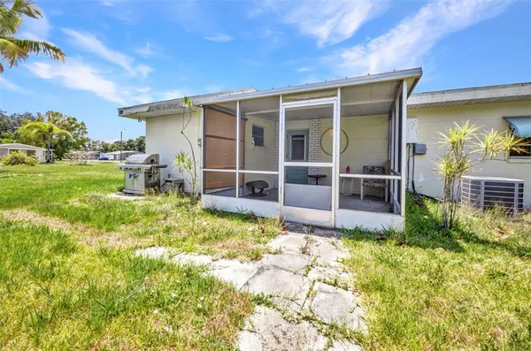 a view of house with backyard porch and furniture