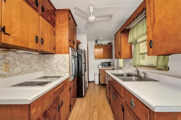 a kitchen with a sink stove and refrigerator
