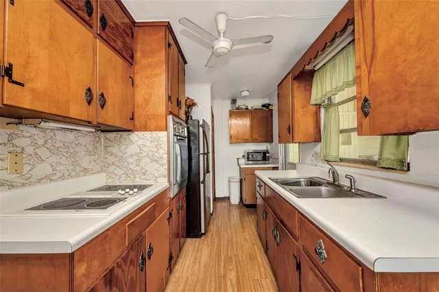 a kitchen with a sink stove and refrigerator