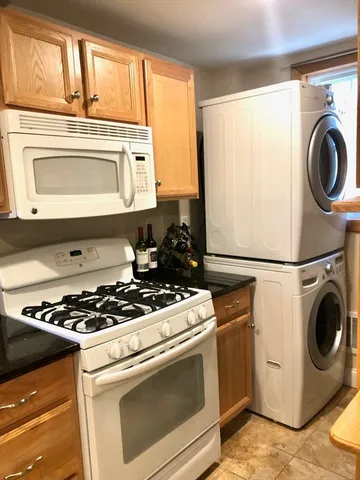 a stove top oven sitting inside of a kitchen