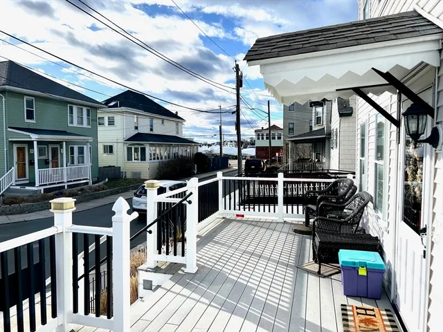 a view of a patio with couches chairs and wooden floor