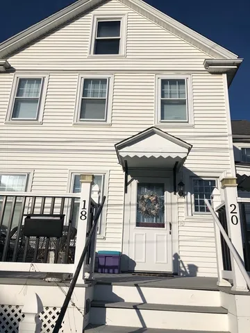 a view of a house with more windows and wooden stairs