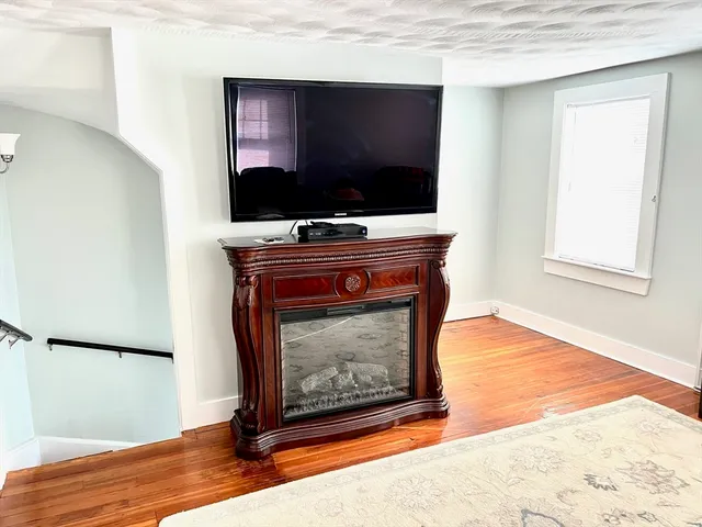 a living room with a fireplace and a flat screen tv