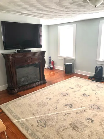 a living room with fireplace furniture and a flat screen tv