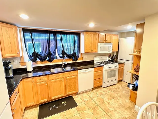 a kitchen with a sink window and cabinets