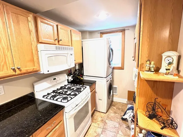 a kitchen with a stove a refrigerator and wooden cabinets