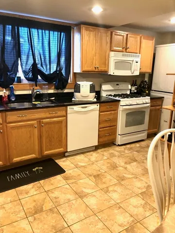 a kitchen with granite countertop a stove a sink and a granite counter tops