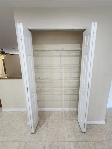 a view of an empty room with a ceiling fan