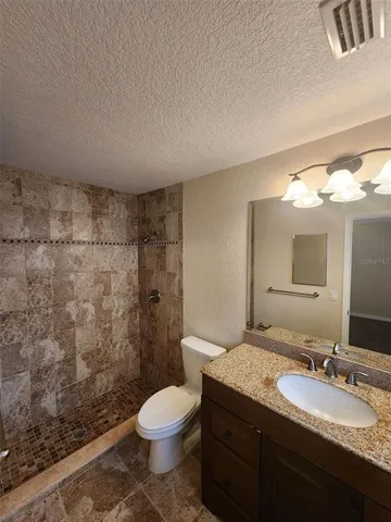 a bathroom with a shower toilet and sink