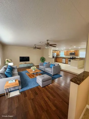 a living room with furniture and a wooden floor