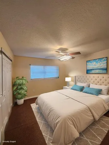 a bedroom with a bed and a potted plant