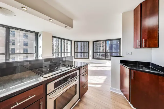 a kitchen with stainless steel appliances granite countertop a stove and a sink
