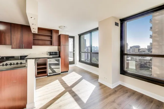 a kitchen with kitchen island granite countertop a stove top oven