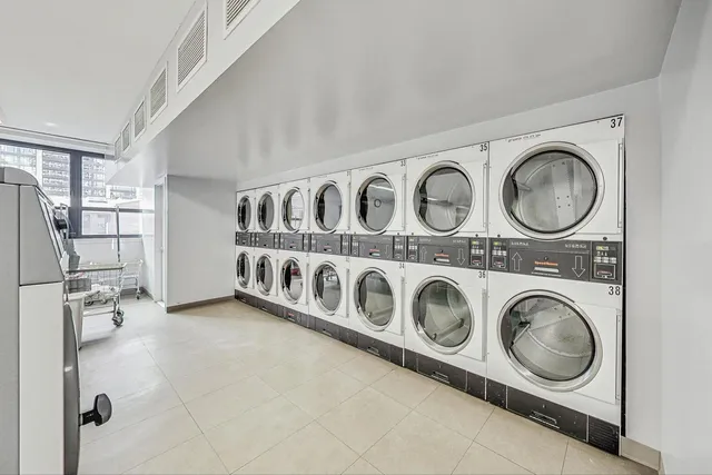 a utility room with stainless steel appliances washer and dryer