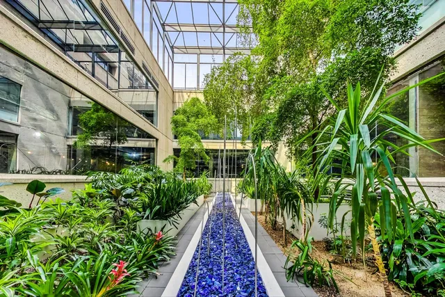 a view of a pathway of a house with flower garden